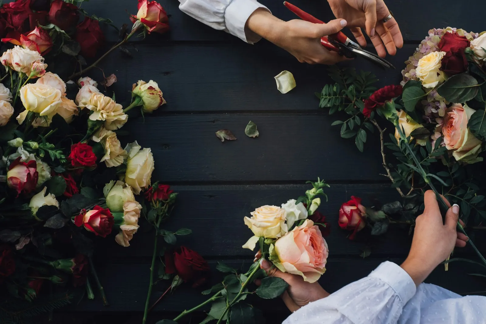 Manos componiendo rosas para un evento